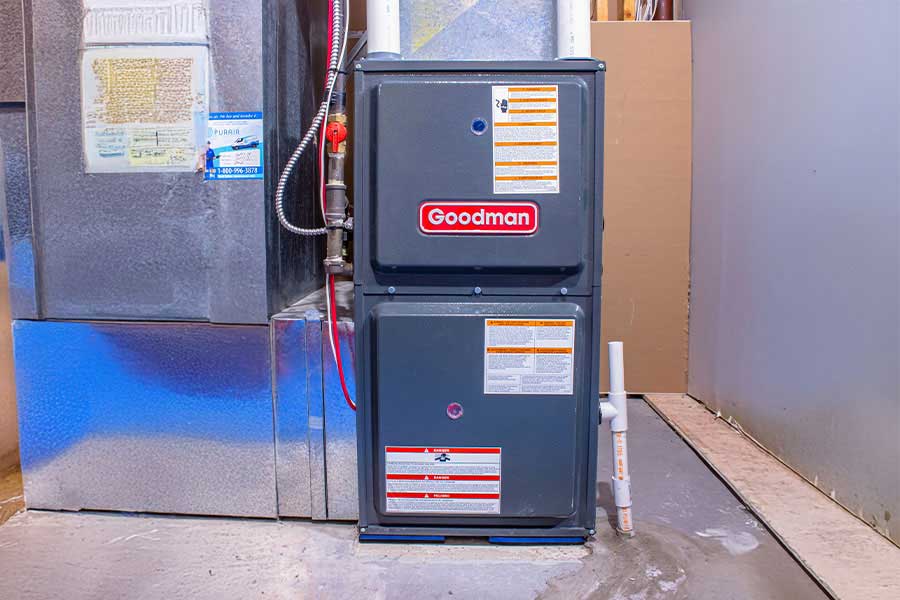 Goodman gas furnace installed beside metal ductwork